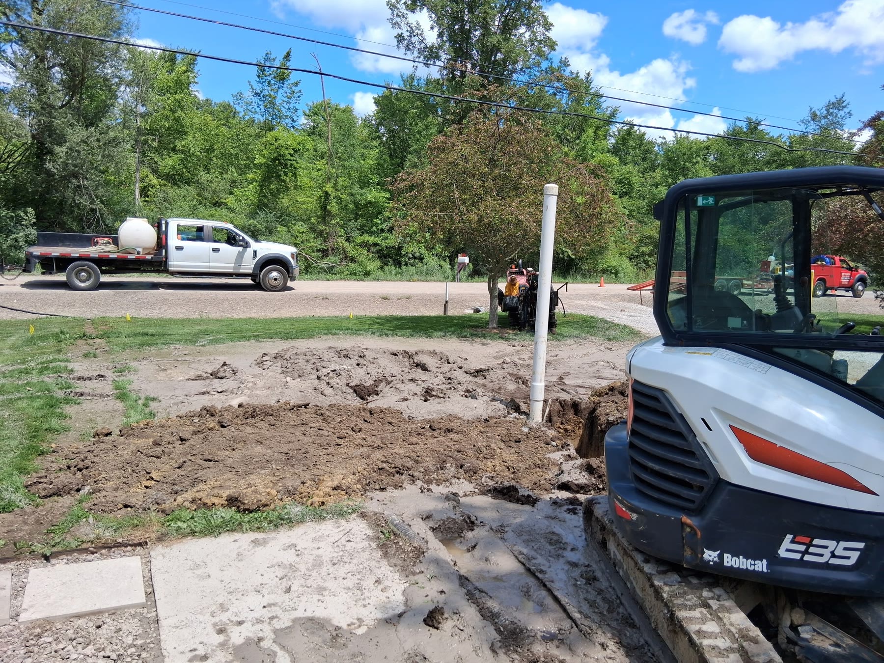 Bobcat excavator supporting an underground utility installation